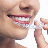 close up of woman putting invisalign in her mouth