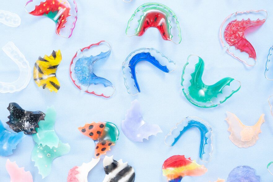 multicolored retainers placed on top of a pale blue background